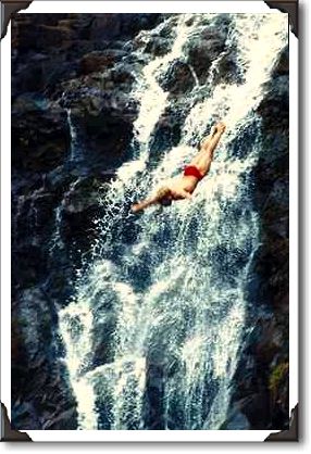 Cliff divers against waterfall Cliff divers against waterfall