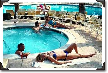 Couples around hotel pool in Palm Springs, California Couples around hotel pool in Palm Springs, California