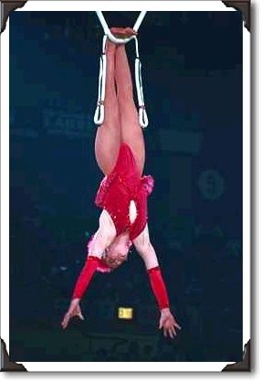 Acrobat hanging from rope, Shrine Circus, New York Acrobat hanging from rope, Shrine Circus, New York