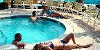Couples around hotel pool in Palm Springs, California