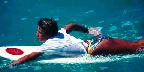 Surfer girl paddling, Hawaii