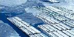 A grain barge slowly navigates the frozen Mississippi River